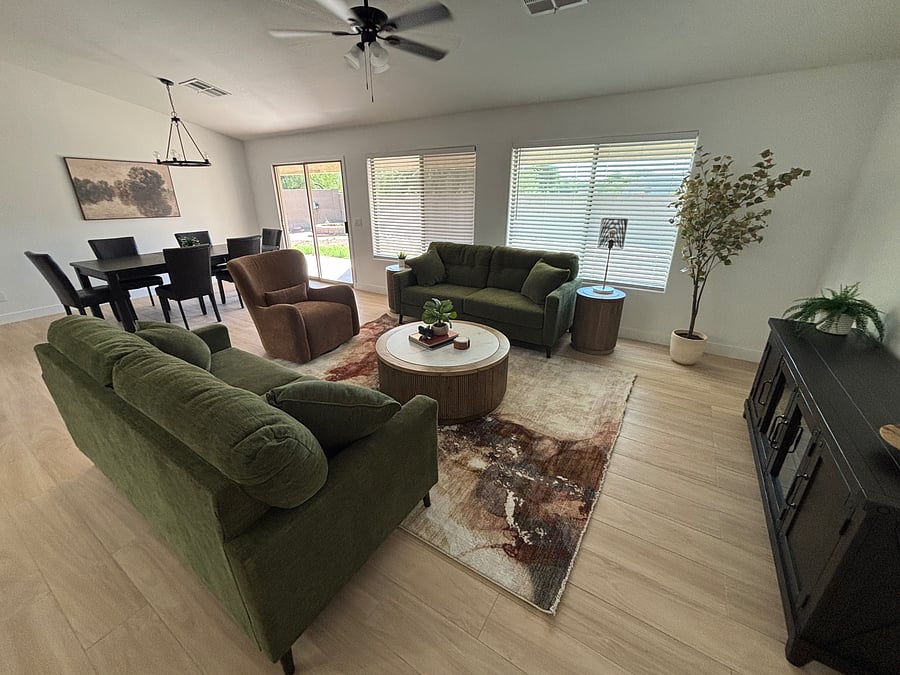 Large, inviting family room with seating for 8 at the dining table and additional bar seating