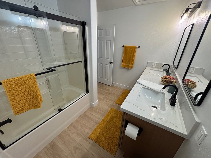 Bathroom 2 features full tub and shower, dual sinks, storage and beautiful finishes