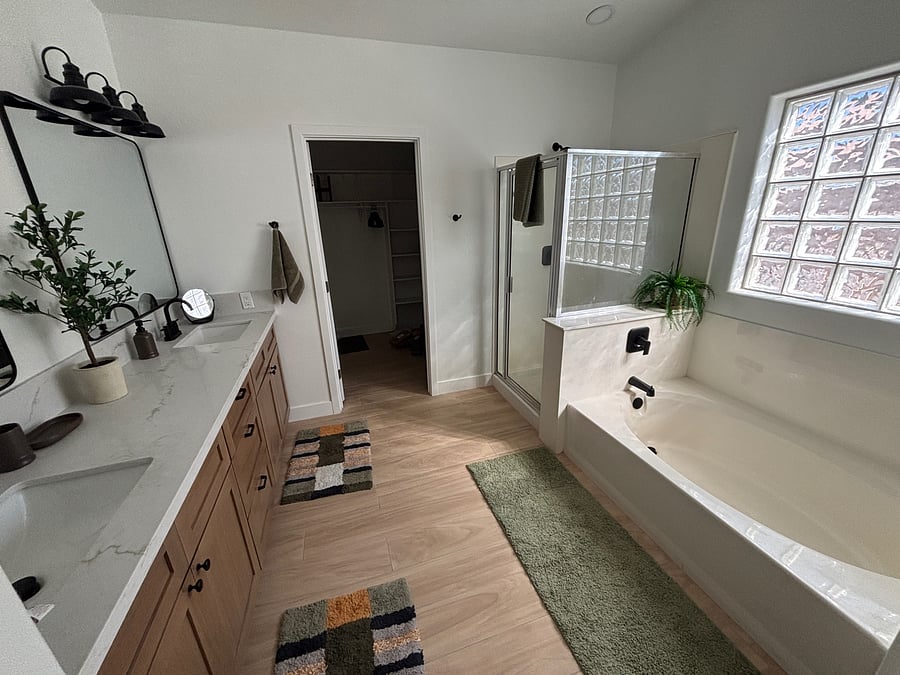 Primary bathroom with garden tub, water closet, stand up rain shower, and large walk-in closet