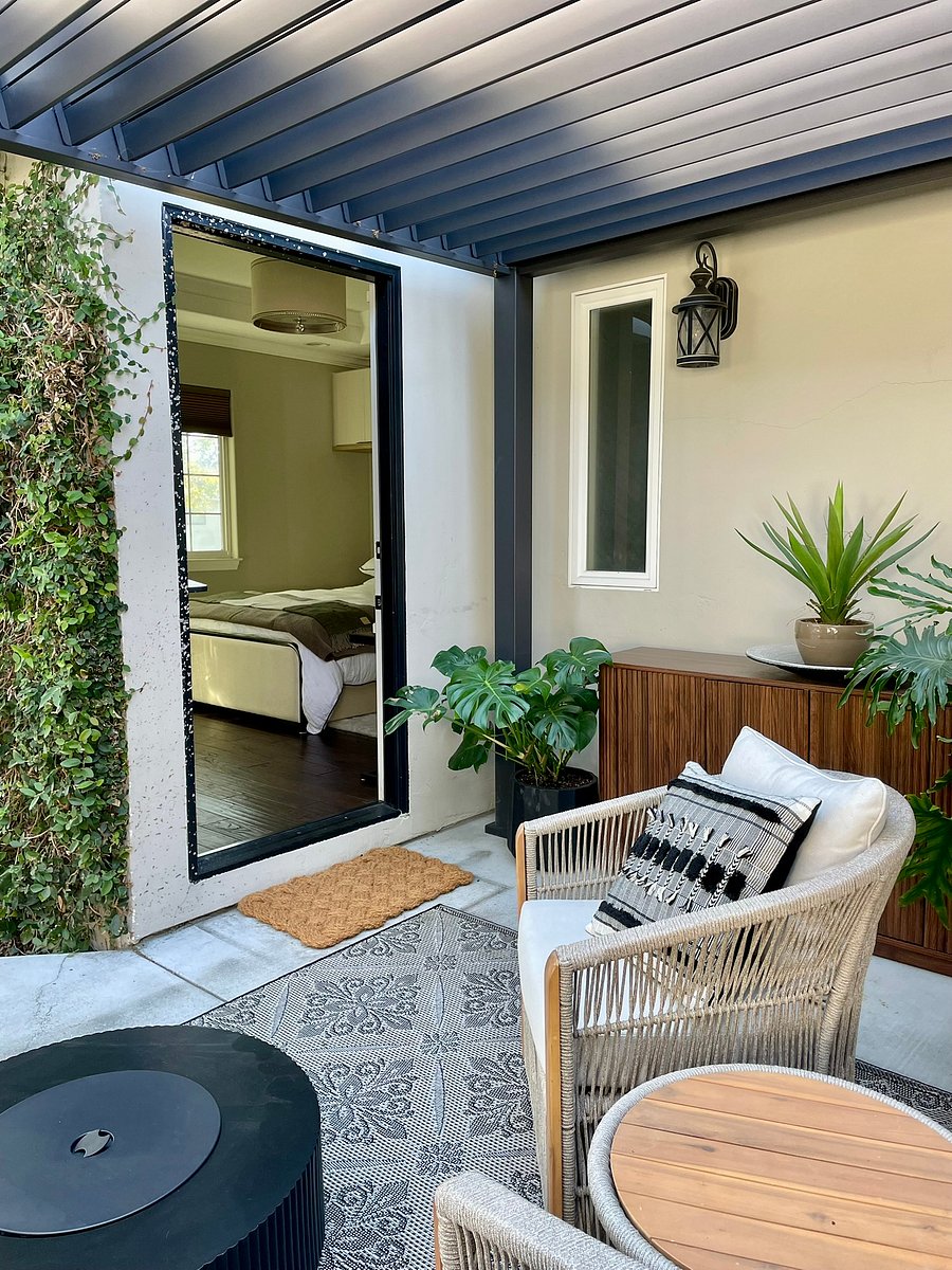 Enjoy your own private-use, louvered outdoor patio featuring comfortable woven seating, a fire table, and a seamless indoor-outdoor living.