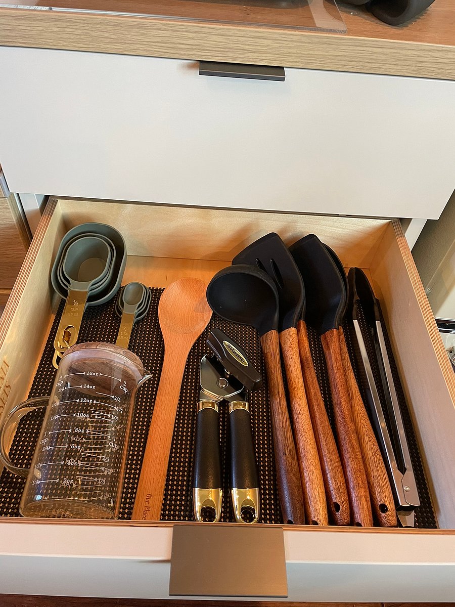 Fully equipped kitchen drawer stocked with cooking utensils, measuring cups, and essential prep tools.