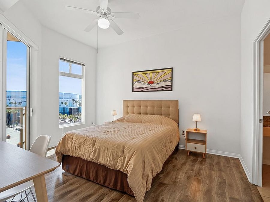 Your cozy, private en-suite room featuring a queen bed and a dedicated workspace