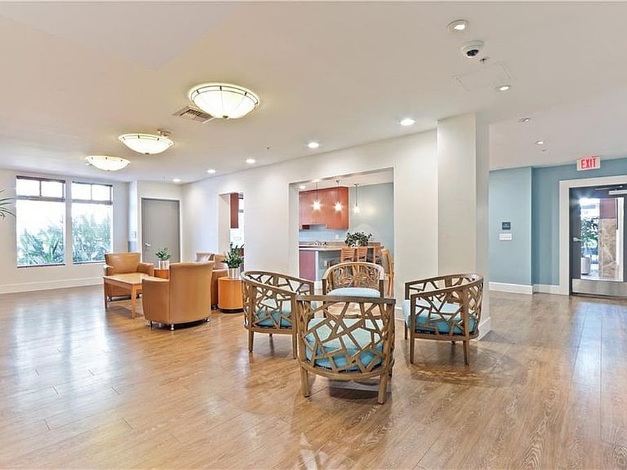 Community club room featuring comfortable seating and entertainment space, available for reservation
