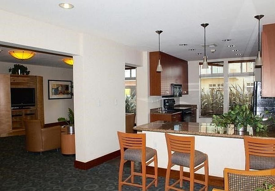 Community club room featuring comfortable seating and entertainment space, available for reservation