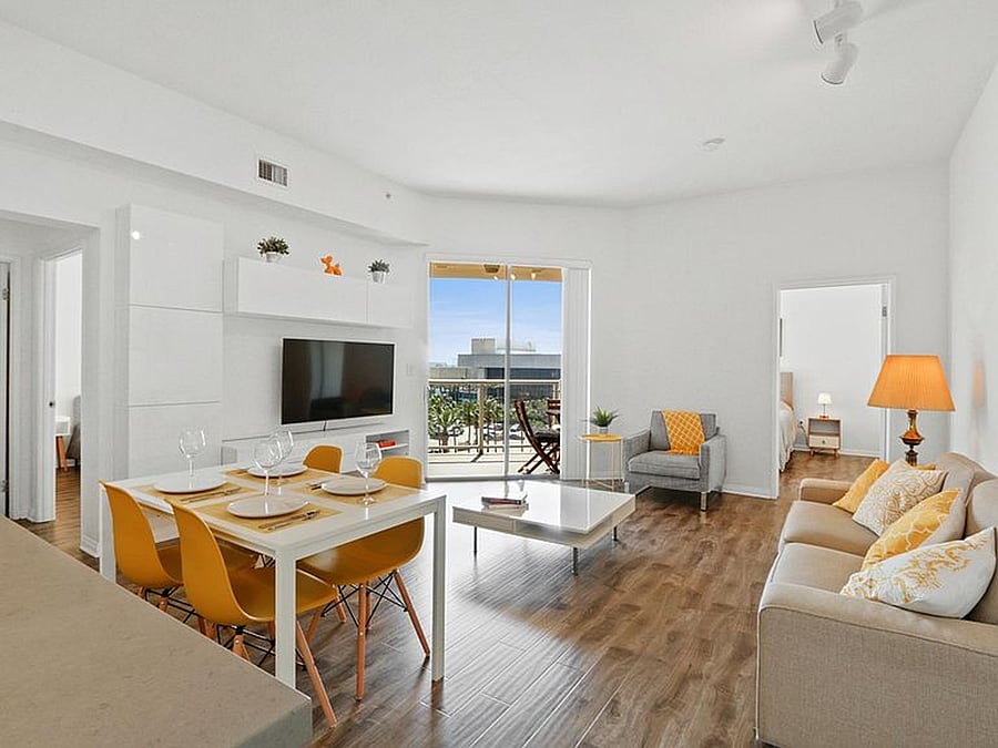 Modern shared living room and dining area with direct balcony access