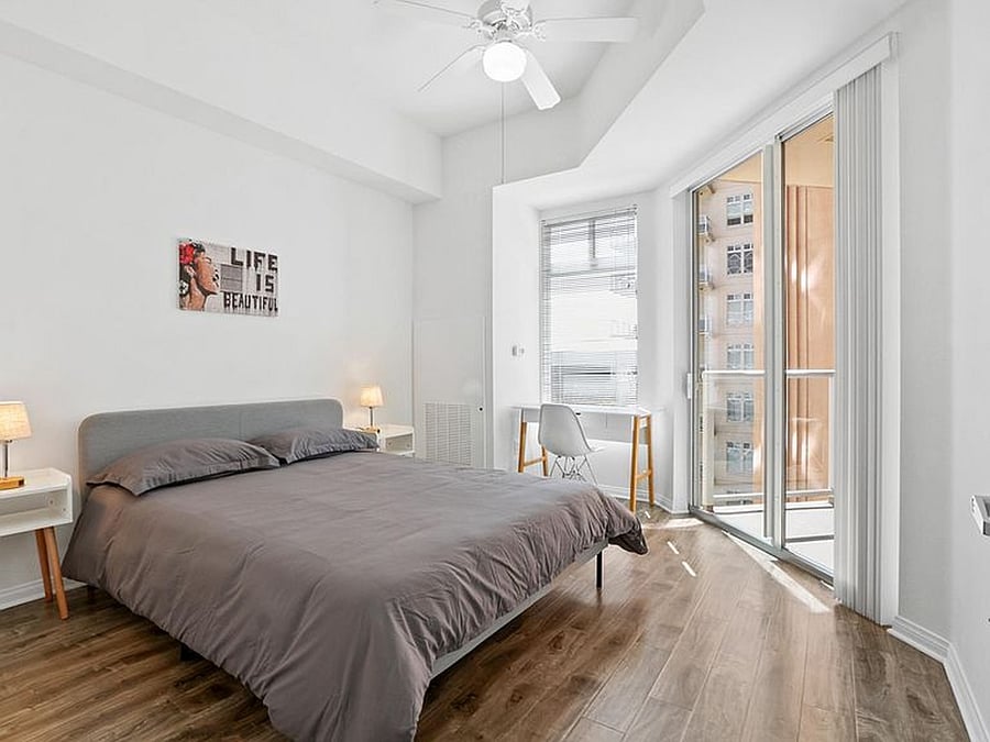 Your cozy, private bedroom featuring a queen bed and a dedicated workspace
