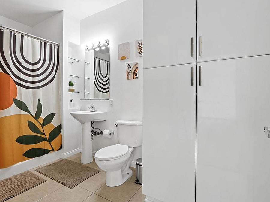 Spacious private bathroom featuring a large walk-in closet right inside