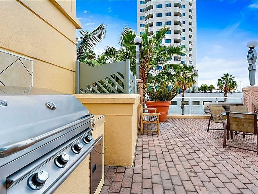Resort-style building amenities including outdoor BBQ area