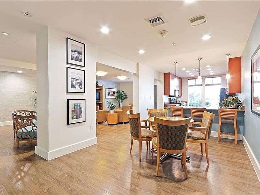 Community club room featuring comfortable seating and entertainment space, available for reservation