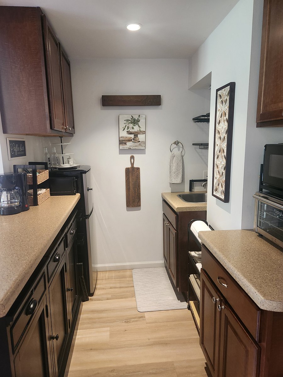Fully equipped kitchen down to the silverware, coffee maker and utensils.