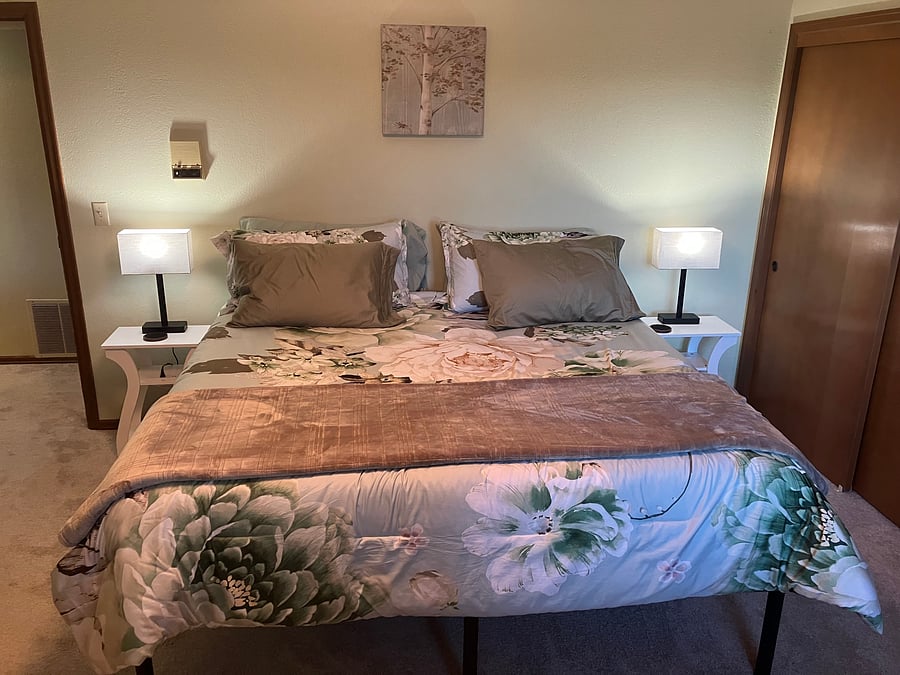 5th bedroom downstairs. has big view out windows on the lower level. King size bed closet dresser
