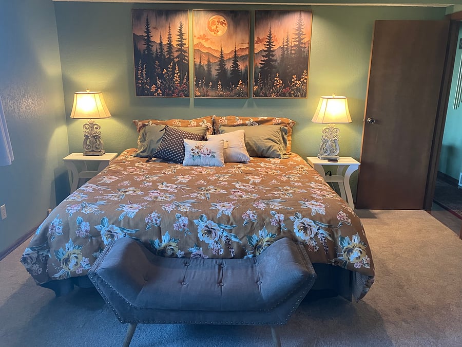 Large Primary Bedroom with attached primary bathroom California king bed. bedside tables with usb and electric plug ins. Large windows with upper level water and mountain views