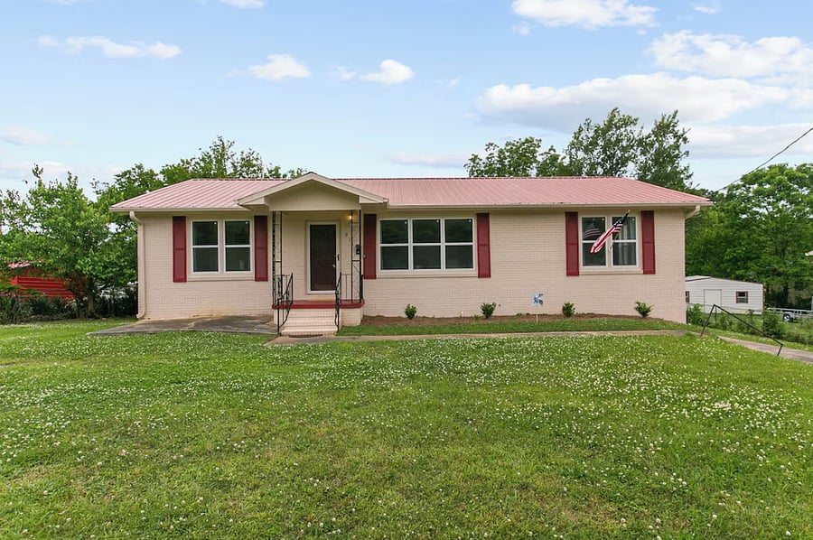 Welcome to Dugan Cottage A-your cozy home away from home in Birmingham, featuring a charming brick exterior, easy access, and a peaceful residential setting.