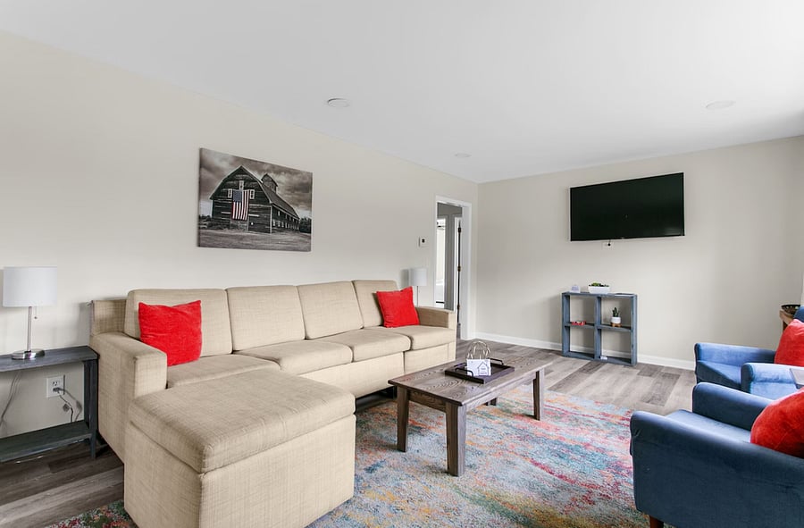 Designed for both lounging and flexibility, the living room includes a queen sofa bed-perfect for accommodating additional guests.