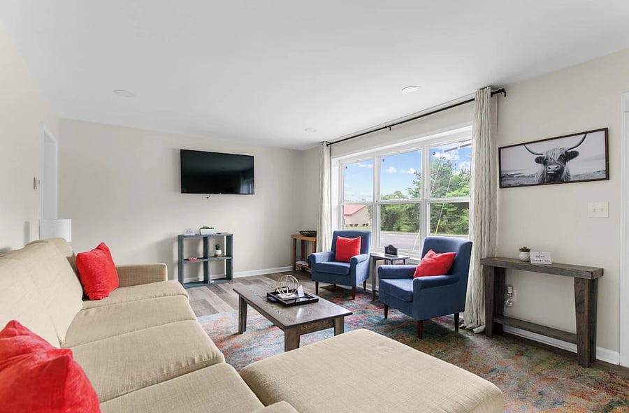 Relax and unwind in a bright, comfortable living room featuring plenty of seating and space to gather after a day out.