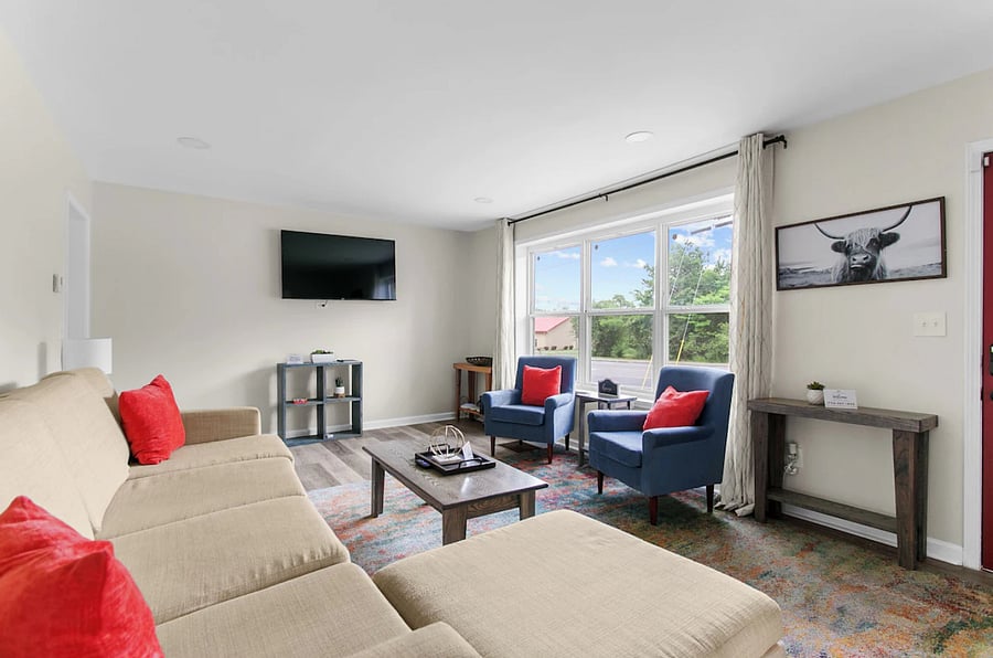 Relax and unwind in a bright, comfortable living room featuring plenty of seating and space to gather after a day out.
