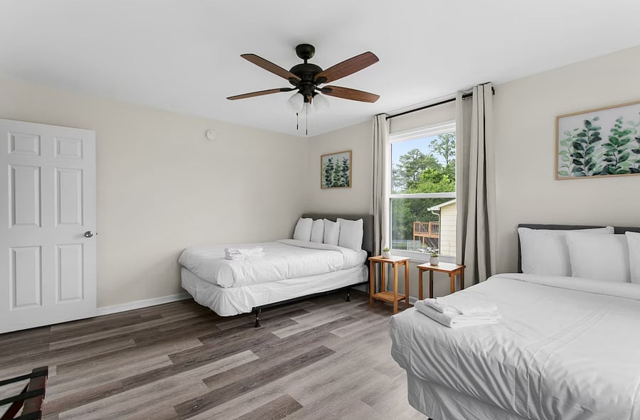 Enjoy flexible sleeping in this spacious bedroom featuring both a queen and a full bed-perfect for families or groups traveling together.