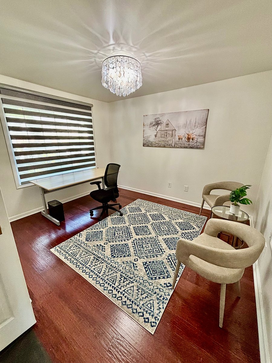 Quiet home office setup with high-speed Wi-Fi space, ergonomic chair, and zebra shades for privacy.