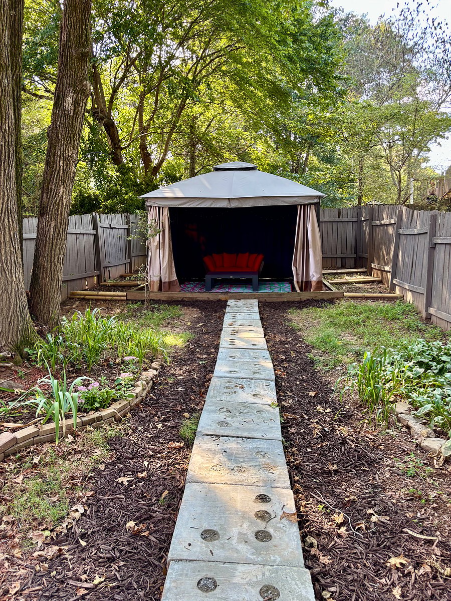 Quiet outdoor gazebo retreat in a private fully-fenced backyard, perfect for unwinding.
