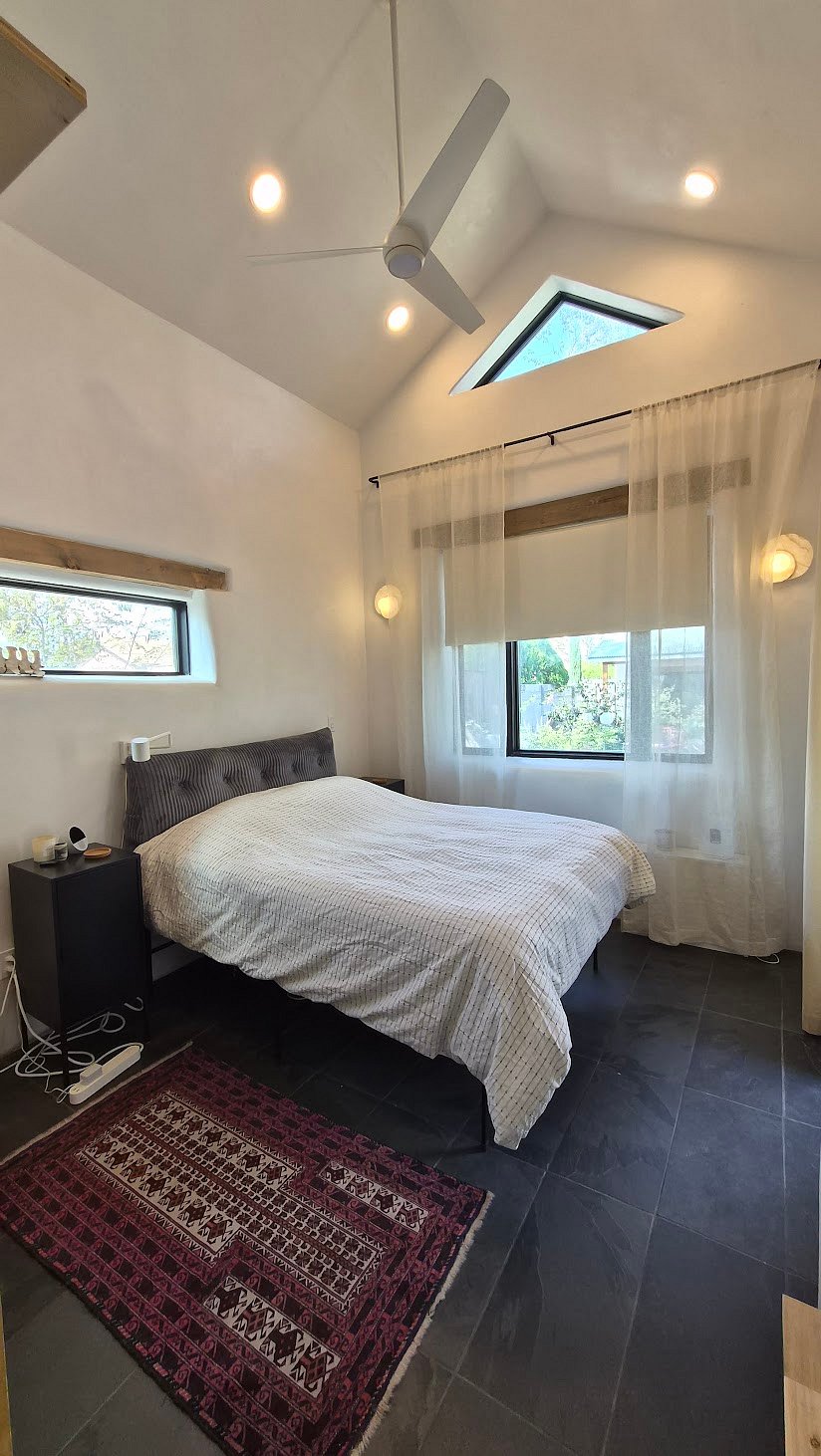 The primary bedroom with a storage loft