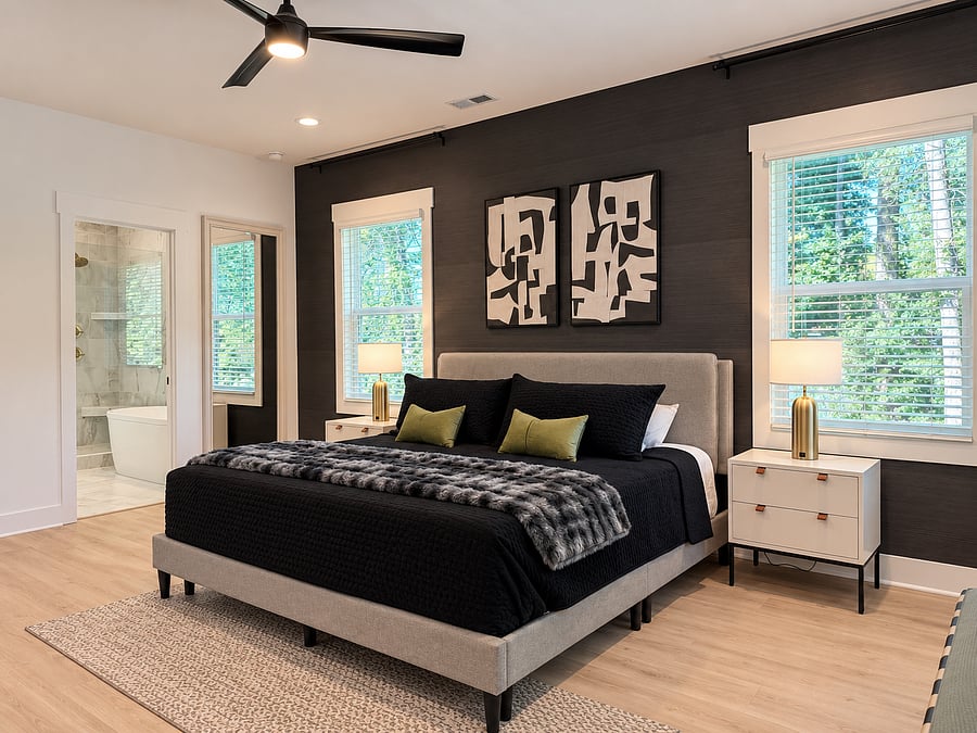 Spacious primary suite with king-size bed and television