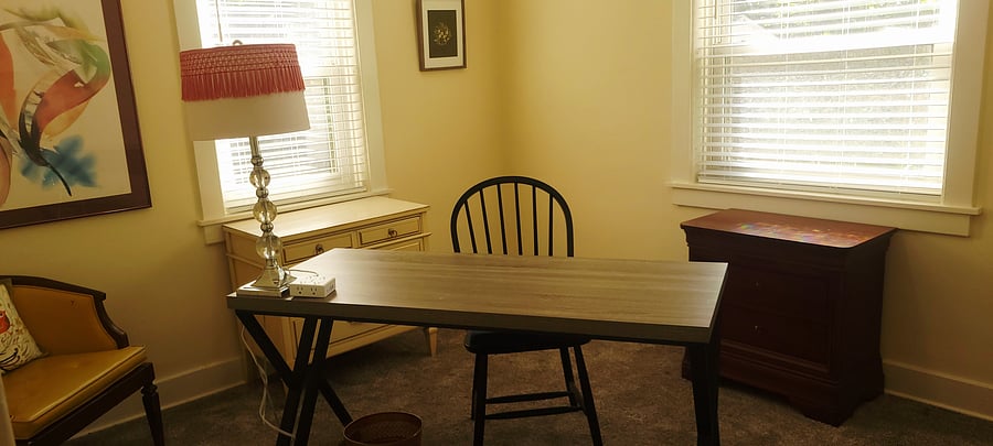 This office doubles as a dressing room with a lighted closet.