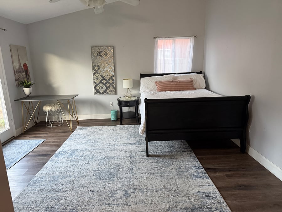 Daytime view with refreshing, ample sunlight, if desired. Black out curtains are also on the windows for privacy and daytime sleeping opportunities. Queen bed with provided bedding: comforter, shams, sheets and pillows cases.
