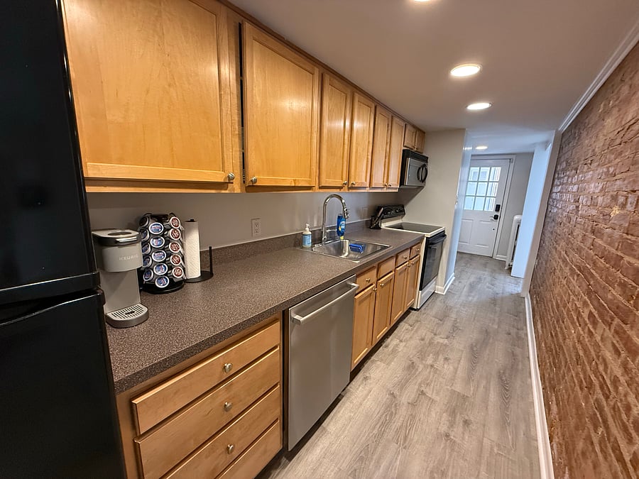 Kitchen includes full-size refrigerator, dishwasher, stove, and microwave. All cooking basics are included.