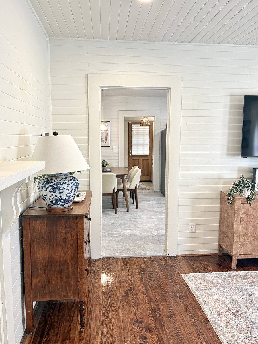 View from the living room. Kitchen and pantry on the right; laundry room straight through into a nook just before the wood back door. Rooms and bathroom on the left.