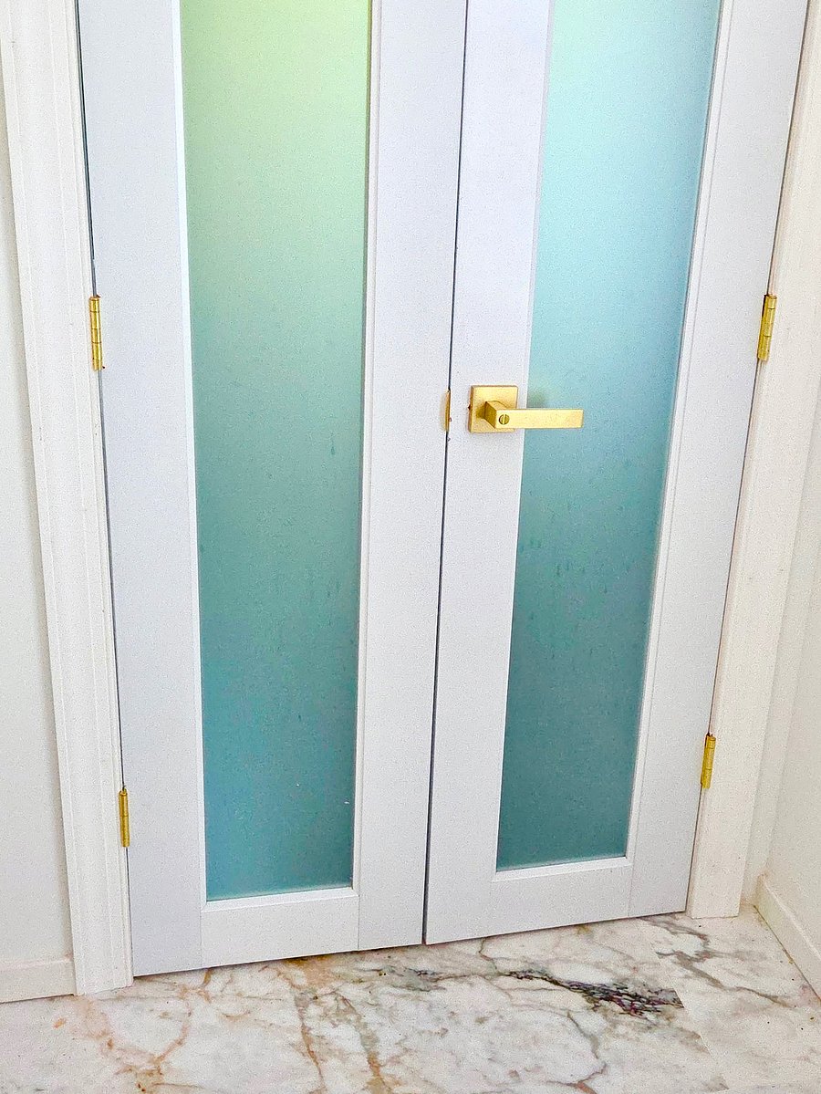 Spa bath features double frosted doors for privacy and light.
