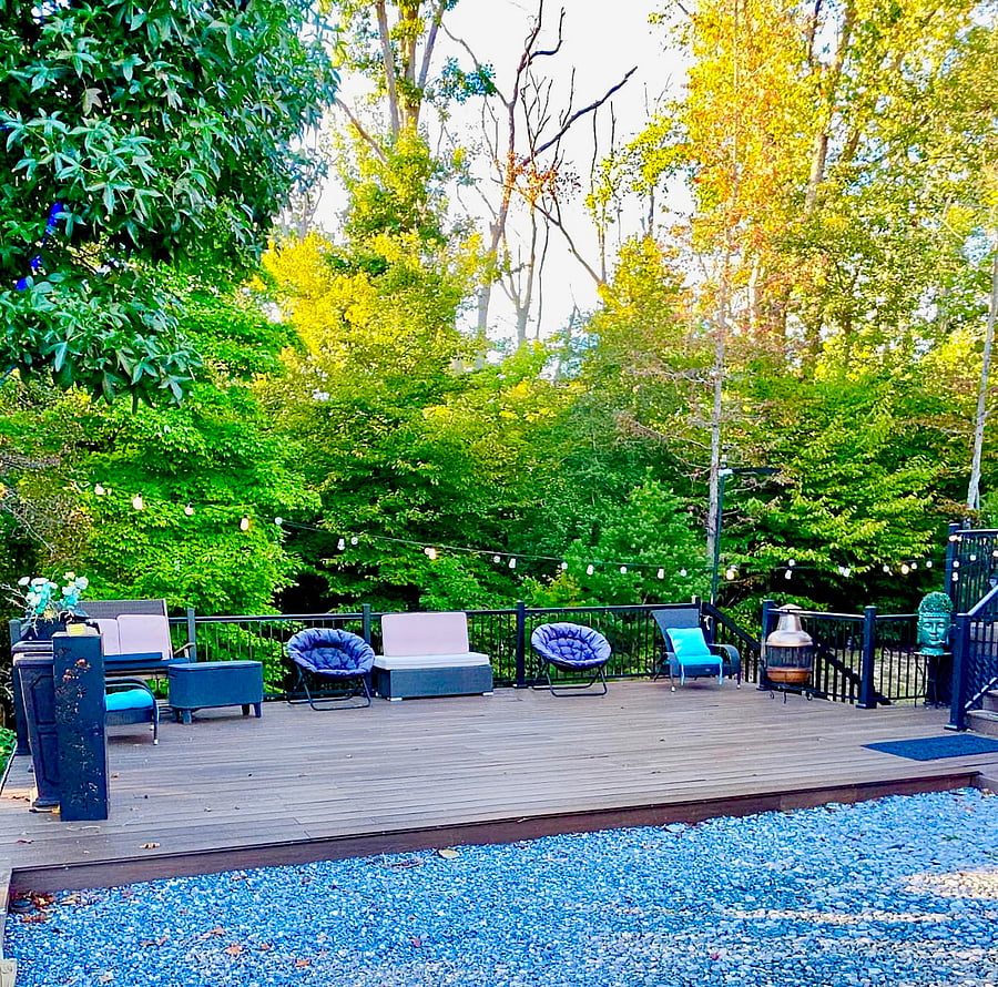 An expansive outdoor lounge offers a choice of comfortable seating against a lush wooded backdrop. Stretch out with a book, enjoy the fresh air, or settle into conversation in a setting that feels peaceful and pleasantly removed from the daily rush.
