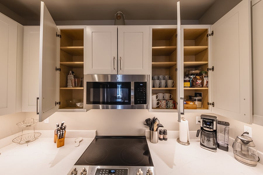 Plenty of coffee mugs, knife block, salt shaker and pepper grinder, coffe pot, and tea kettle.