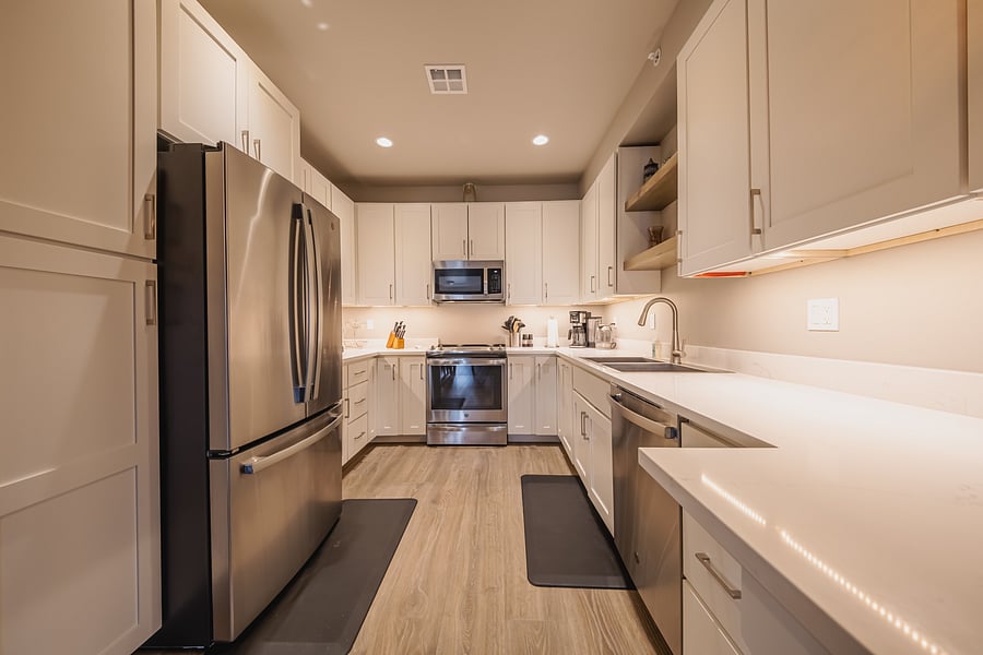 Fully equipped kitchen: fridge/freezer/ice-maker, stove/oven, microwave, dishwasher, Ninja coffee maker (pod or filter), Ninja pizza oven/air fryer/toaster, & a stainless steel double sink.