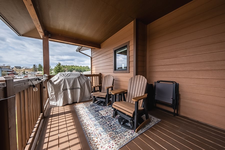 Large deck with a new grill and Amish swivel rockers.
