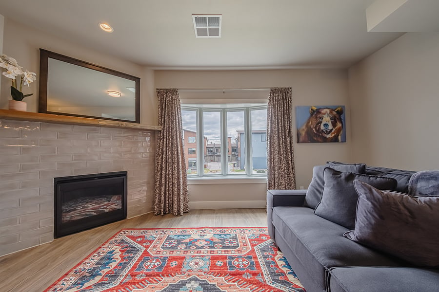 Relaxing Living Room with gas Fireplace, windows galore, comfy sofa, TV with Apple TV!