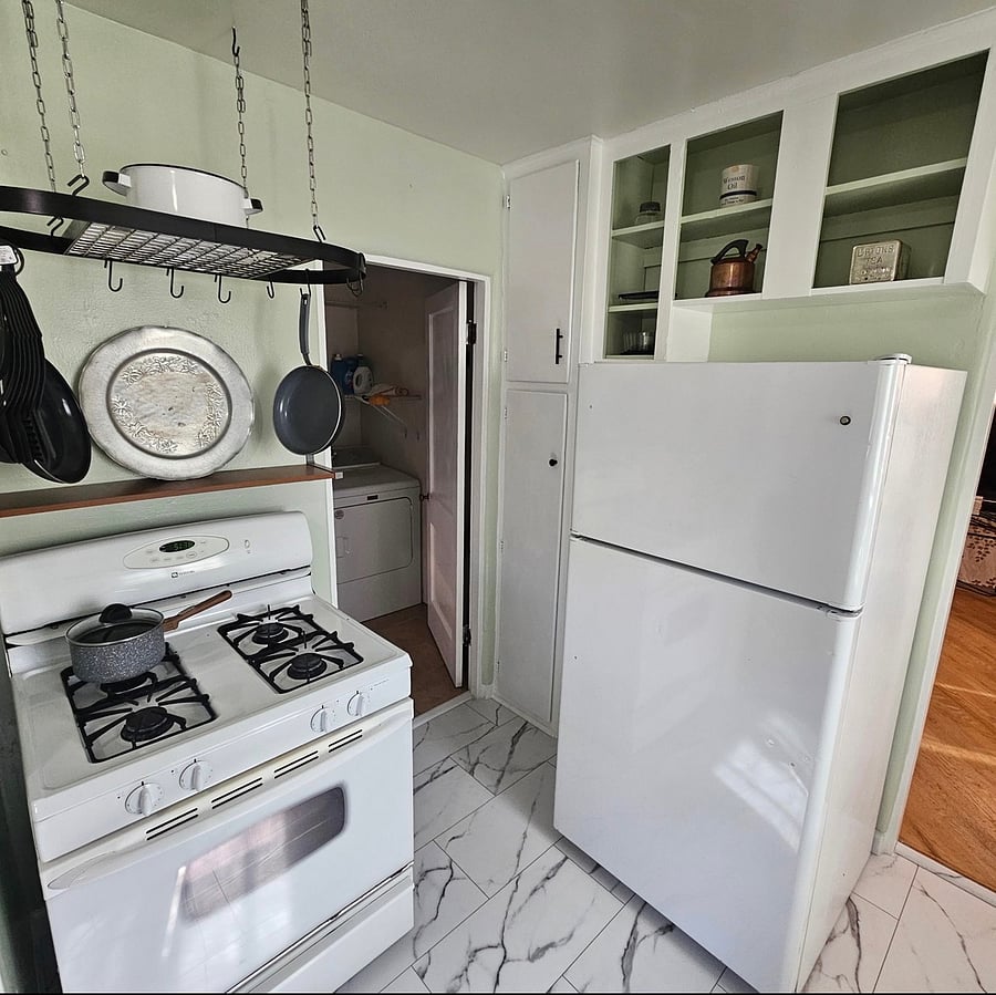 Gas stove top and big refrigerator/freezer.