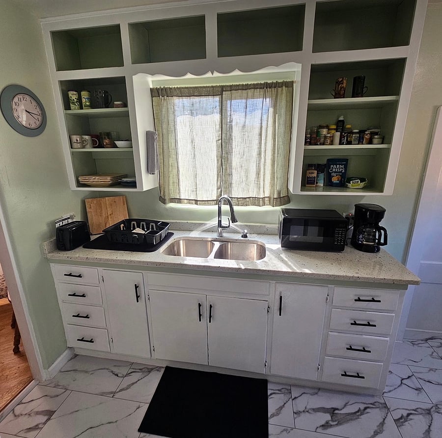 Beautiful marble countertop and original handmade cabinets. Gas stove top. Renovated sink.