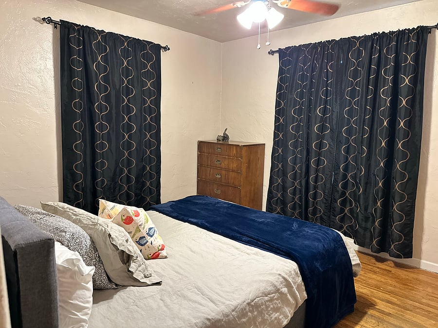Bedroom 1 comfy with hard wood floors, curling fan, a nice big closet, noise machine to help sleep soundly and black out curtains.
