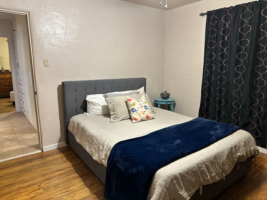 Bedroom 1 comfy with hard wood floors, curling fan, a nice big closet, noise machine and black out curtains to help sleep soundly.