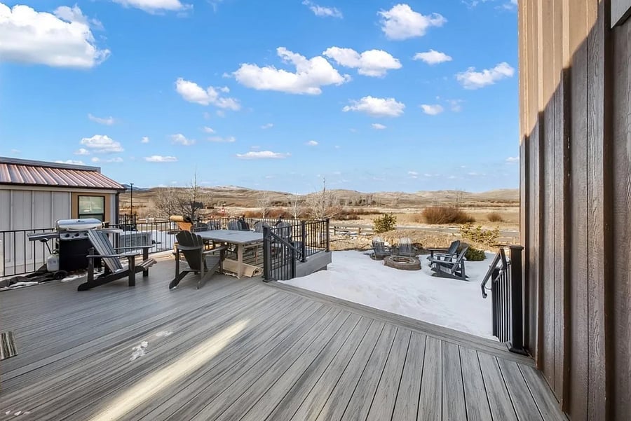 Back deck with seating and outdoor fire pit with Adirondack chairs