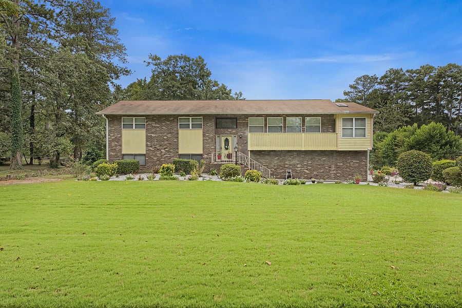 Front of the property on a quiet residential street. Your apartment is on the lower level, with its own private entrance at the back by the carport.