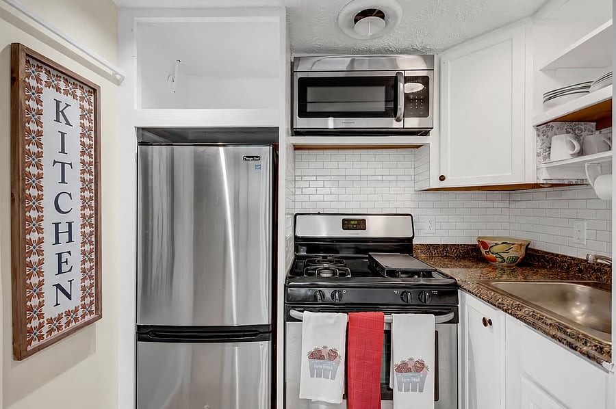 Fully equipped kitchen with stainless fridge, gas range and microwave. Cookware and dishes are provided.