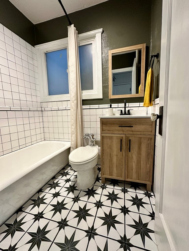 Updated custom bathroom with a full-size tub and shower, statement tile, and plenty of storage.