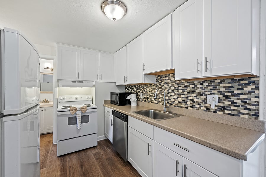 Kitchen with full sized fridge, oven and stove, microwave, dishwasher and all the needed plates, utensils and cooking tools to cook your favorite meal.