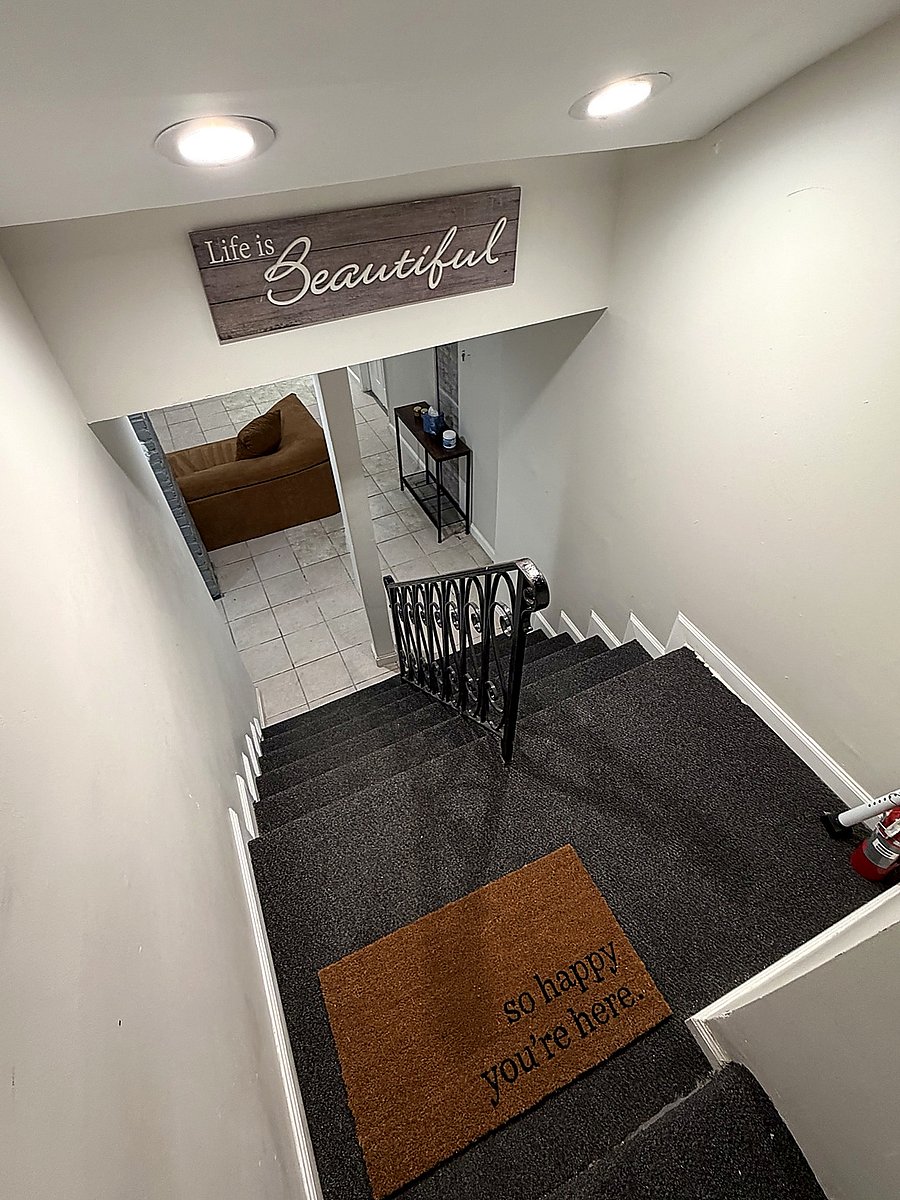 Private stairway leading into the furnished lower-level living space.