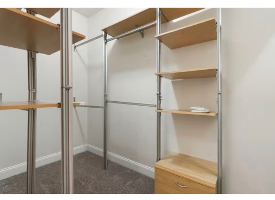 Primary bedroom walk in closet