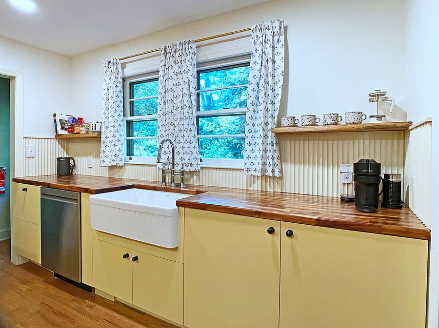 Large kitchen with essentials, dishwasher, microwave, and Nespresso coffee maker.