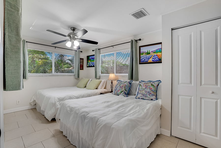 This huge corner bedroom with 3 windows/3 exposures had 2 queen size beds and now has 1 queen size bed; see next photo!
