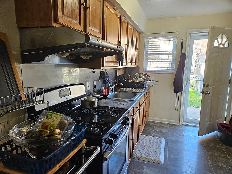 Kitchen, full size fridge and acces to back yard.