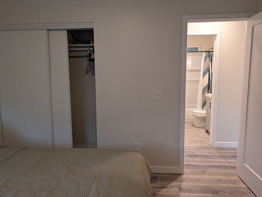 Sliding doors on closet on the left, view from the bedroom through to the bathroom.